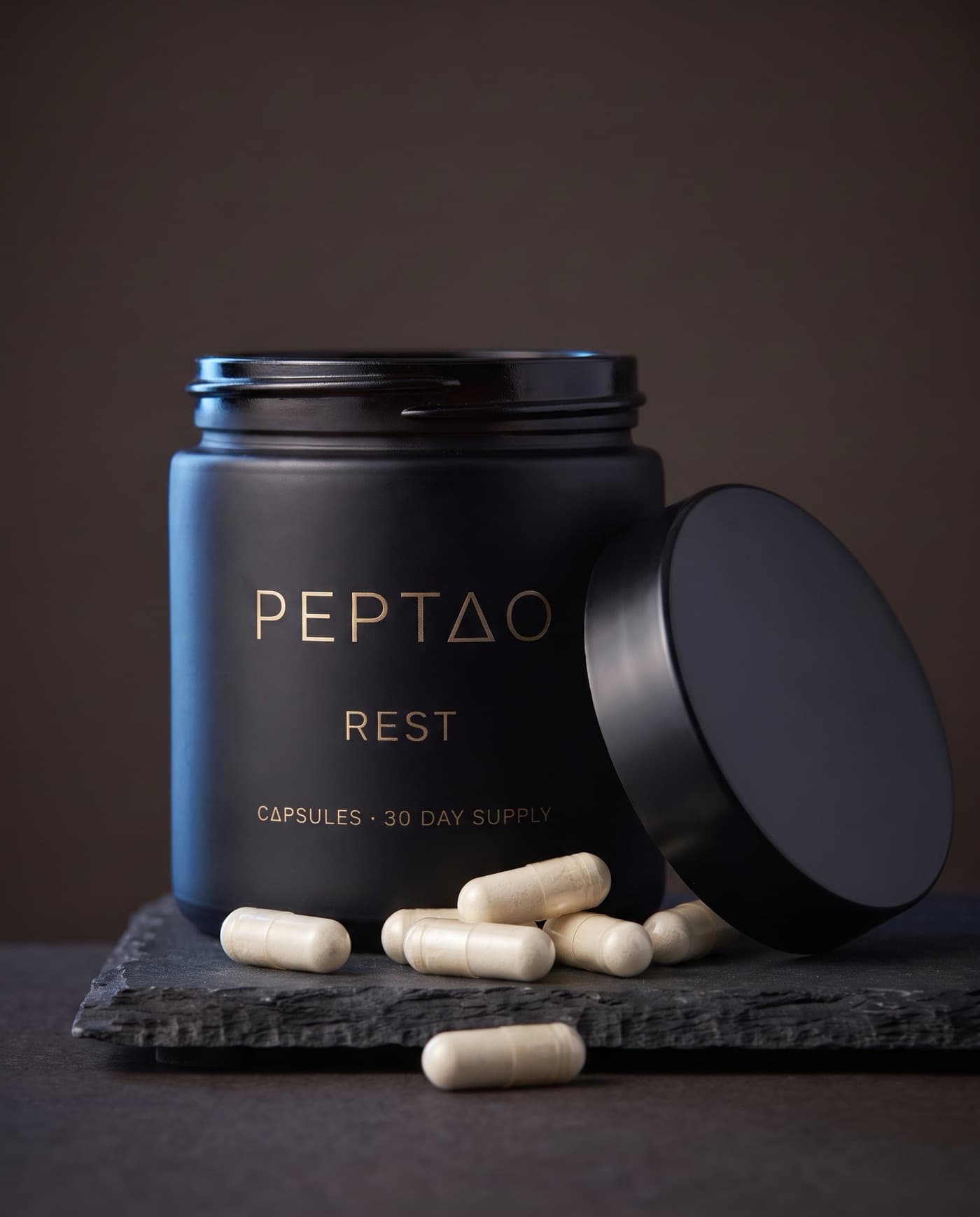 Rest jar open with cream capsules beside it